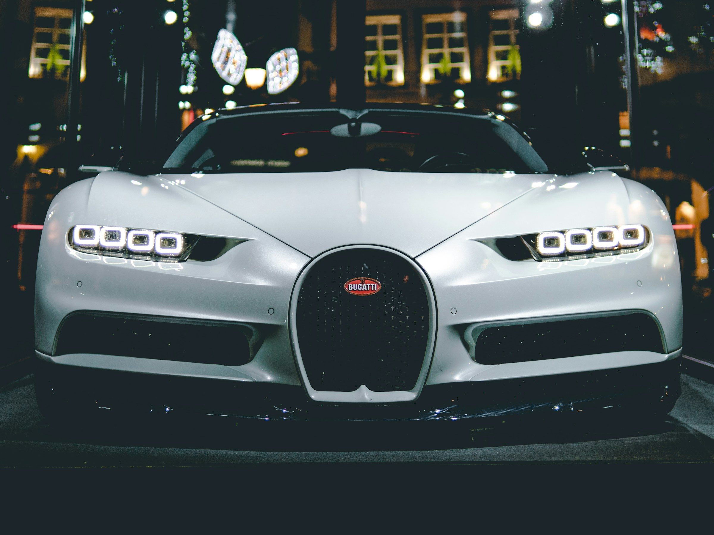 White Bugatti Chiron hypercar at night